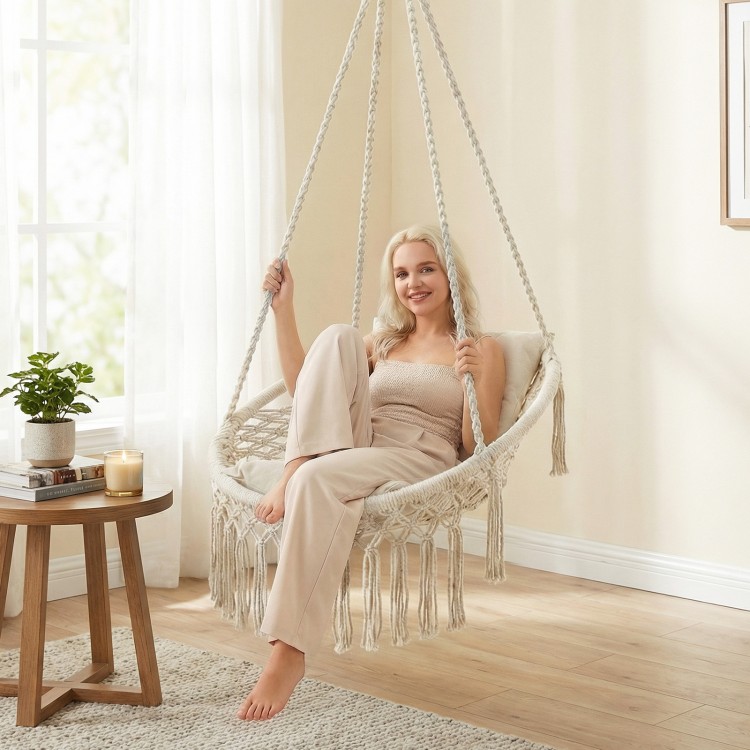 Macrame swing chair in beige with removable cushions, featuring a sturdy metal frame for indoor or outdoor use.