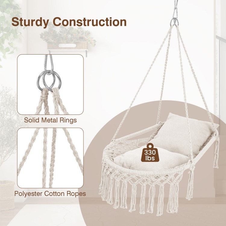 Macrame swing chair hammock in beige with removable cushions, featuring sturdy metal rings and a bohemian design.