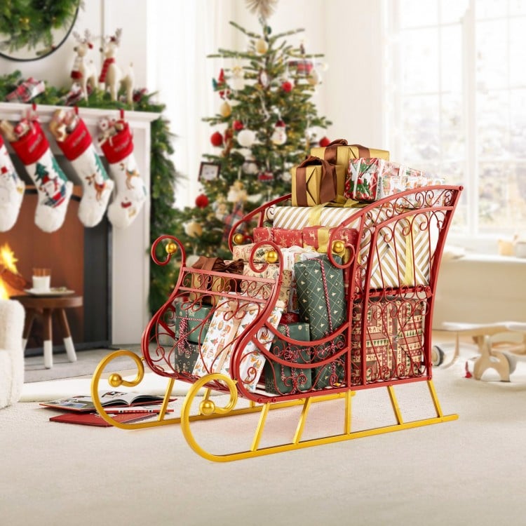 Two-tiered metal Christmas Santa sleigh basket in red and gold, ideal for storing gifts and holiday decorations.