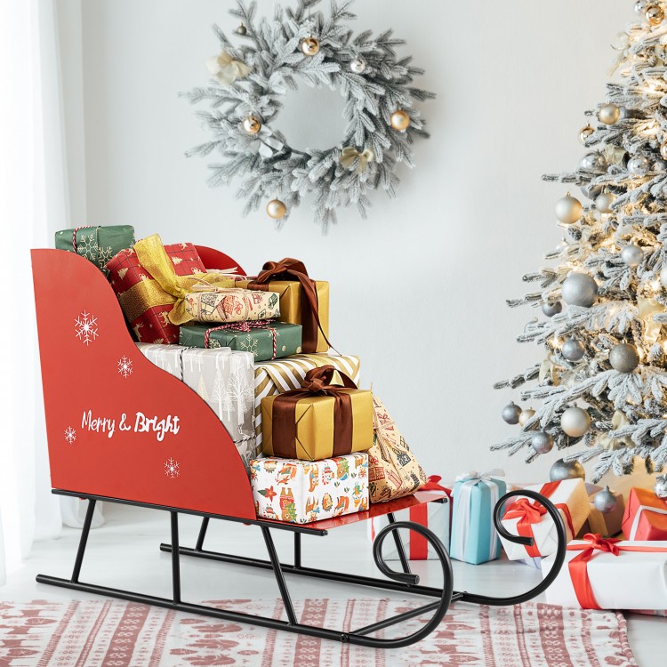 Red metal Christmas Santa sleigh basket filled with gifts, perfect for festive storage and holiday decor.