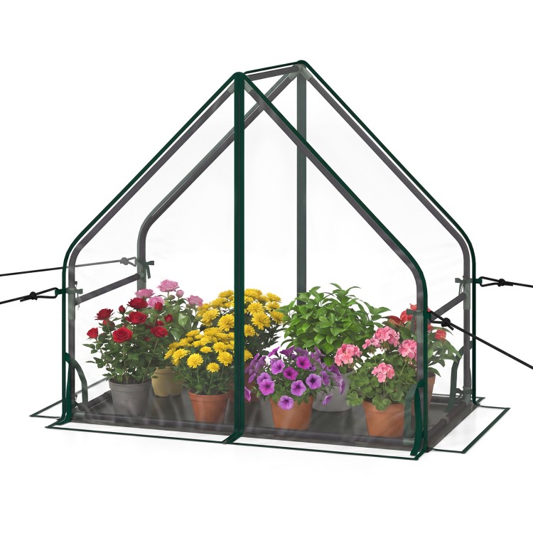 Mini greenhouse with a sturdy metal frame, waterproof bottom mat, and vibrant flowers, ideal for outdoor gardening.