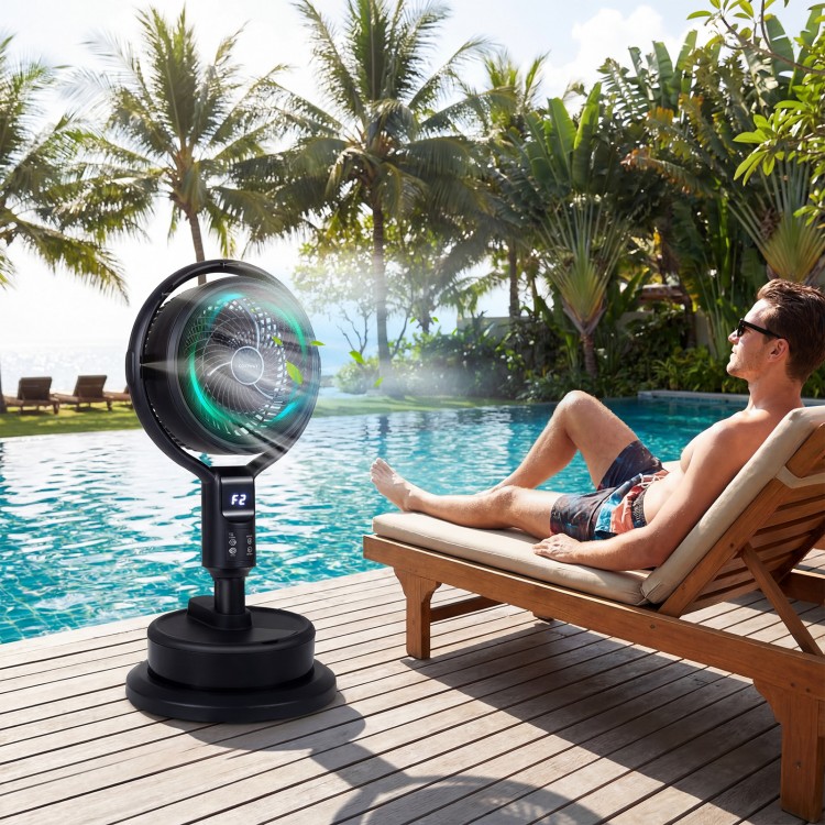 Misting pedestal fan in black with 90° oscillation, positioned by a poolside for enhanced summer comfort.