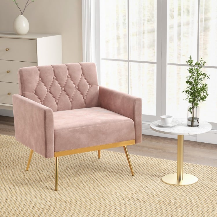 Modern pink velvet accent chair with button tufted back, golden metal legs, perfect for reading or relaxing.