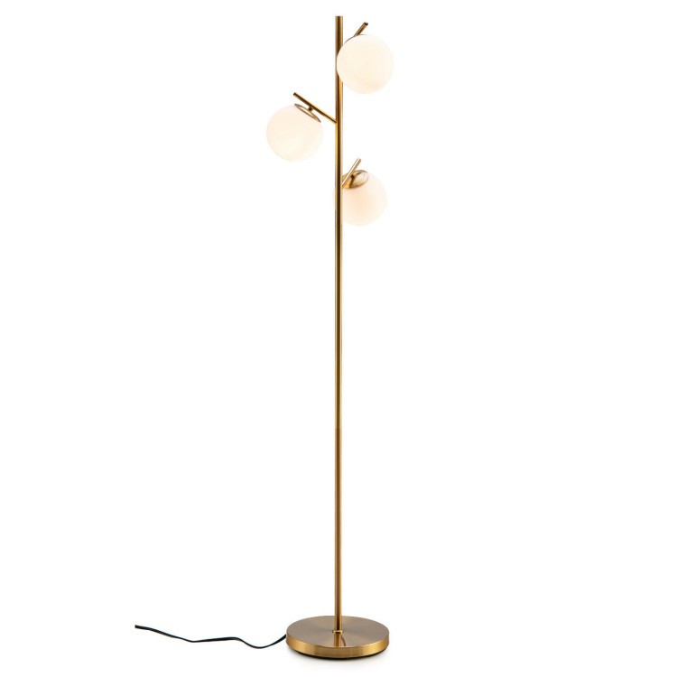 Modern 3-globe floor lamp with a sleek gold finish, providing warm lighting for stylish bedroom decor.