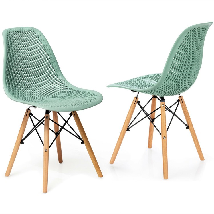 Hollow plastic dining chair in mint green with beech wood legs, showcasing modern design and comfort for small spaces.
