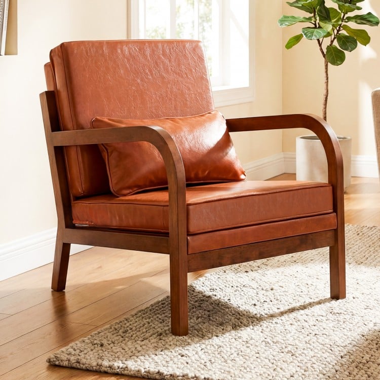 Modern accent chair with brown faux leather upholstery and removable cushions, perfect for living rooms or reading.