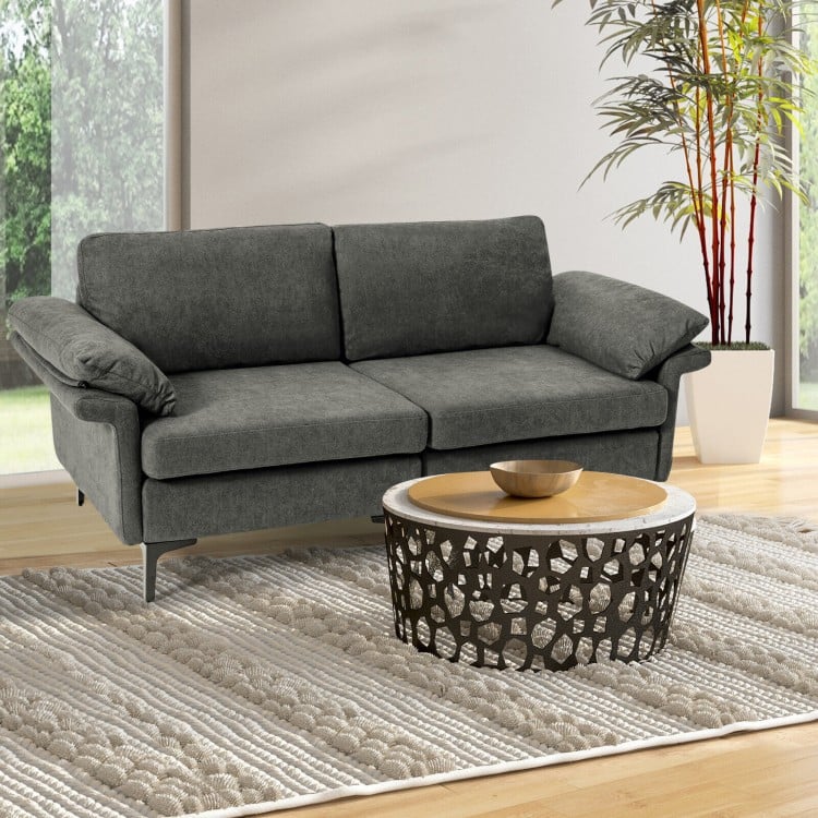 Gray modern fabric loveseat sofa with backrest cushions, arranged with a decorative coffee table in a stylish living.