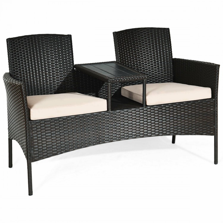 Modern patio conversation set featuring a rattan frame, beige cushions, and a trapezoid coffee table for outdoor.
