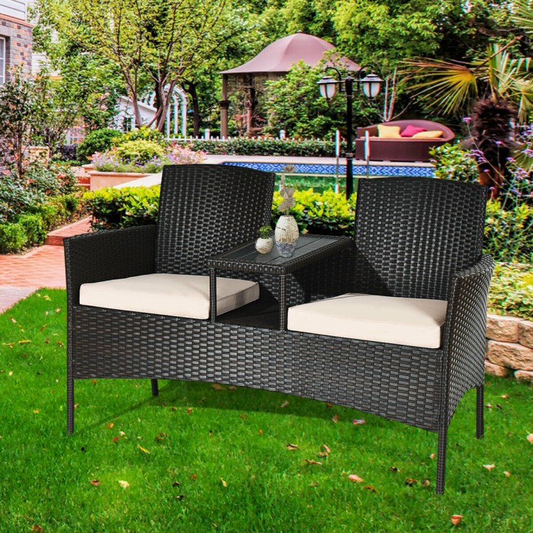 Modern patio conversation set featuring a trapezoid coffee table and beige cushions, perfect for outdoor relaxation.