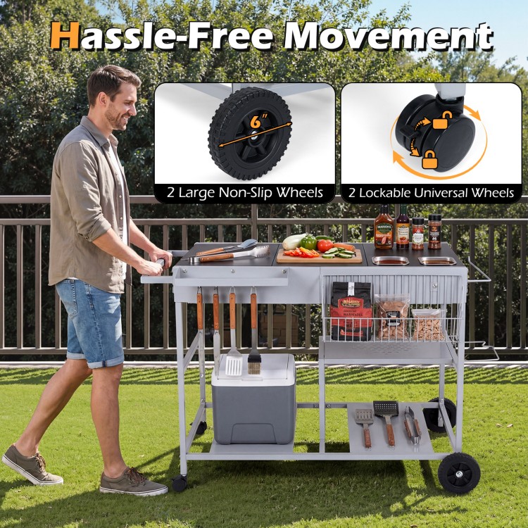 Movable grill table with spacious tabletop, stainless steel condiment caddies, and lockable wheels for backyard BBQs.