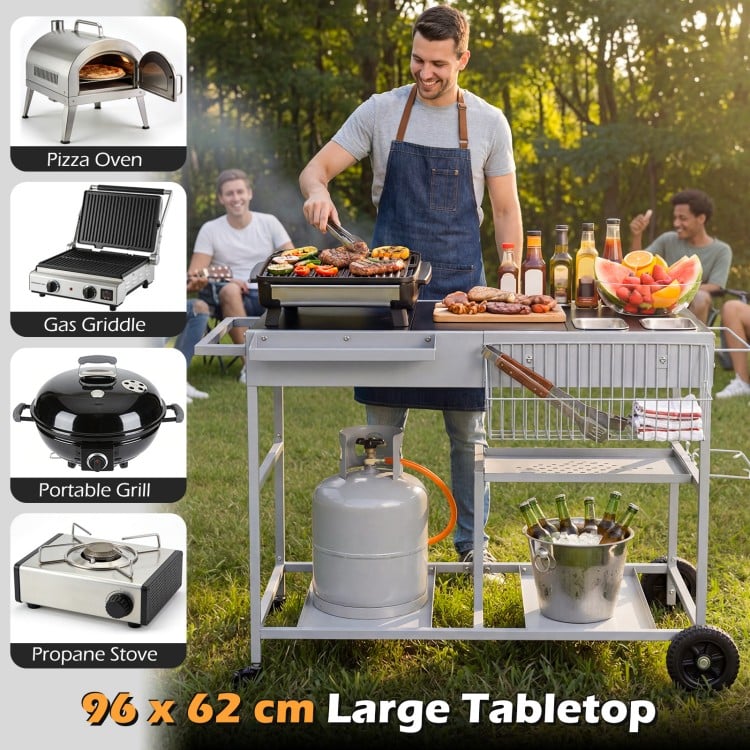Movable grill table with spacious 96 x 62 cm tabletop, stainless steel condiment caddies, ideal for backyard BBQs.