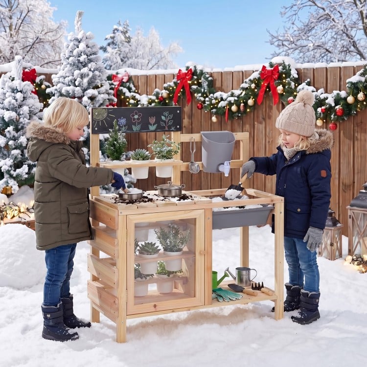 Mud kitchen playset with sink, plant cups, and stainless steel kitchenware for outdoor fun and gardening activities.