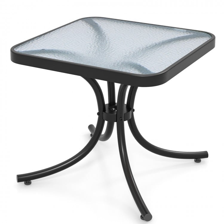 Tempered glass top patio table with heavy-duty metal frame, ideal for garden or poolside use, featuring rounded corners.