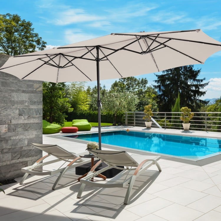 Double-sided beige patio umbrella with 48 LED lights, ideal for outdoor shading by the poolside or garden.