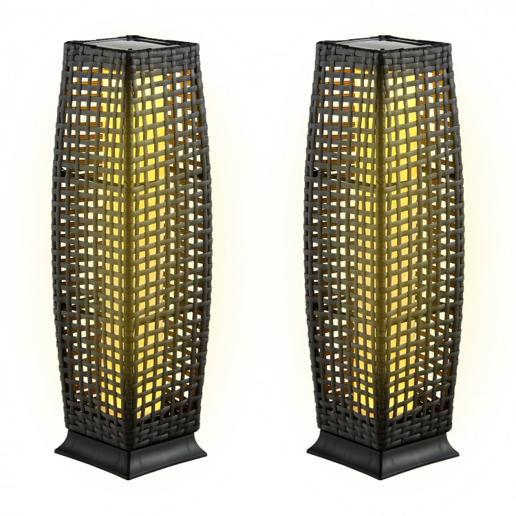 Two solar-powered black wicker floor lamps with warm yellow light, perfect for outdoor patio and garden use.