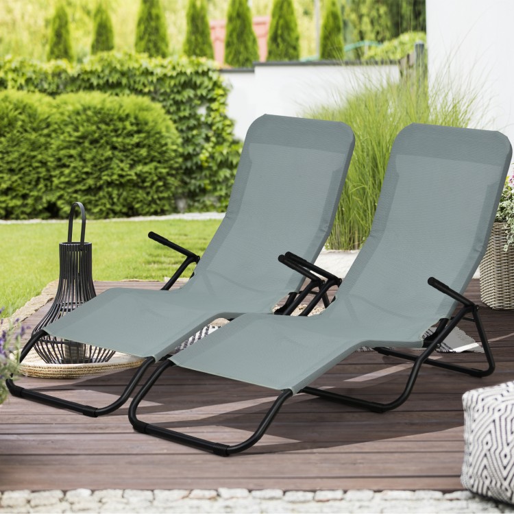 Two light green folding patio chaise loungers with rocking design, ideal for outdoor relaxation in the garden or.