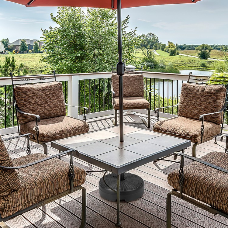Heavy-duty round umbrella base stand with a fillable reservoir for stability, suitable for patio and garden use.