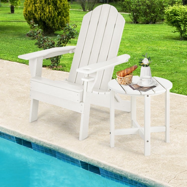 White 18-inch round weather-resistant side table beside an Adirondack chair, perfect for outdoor use by the pool.