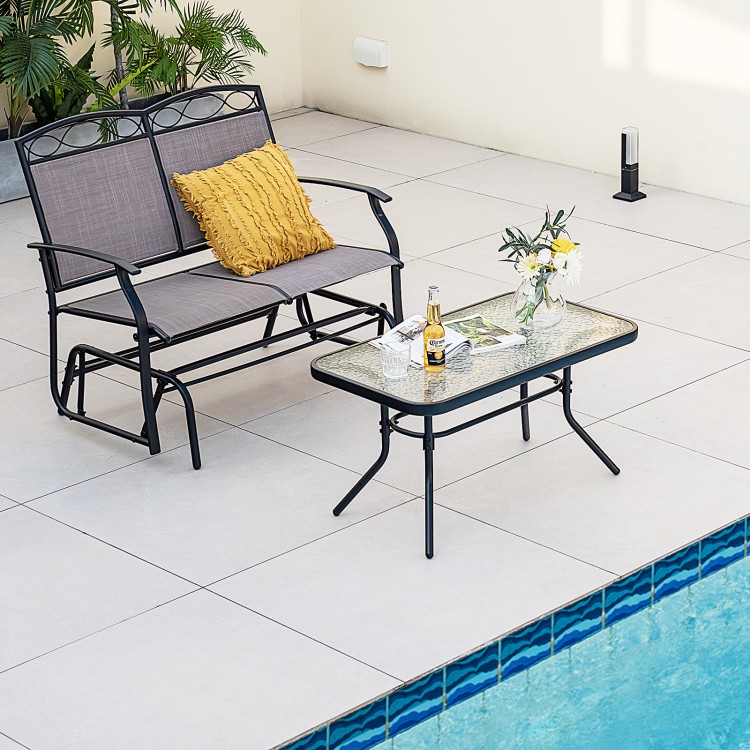 Outdoor gliding loveseat chair with a tempered glass coffee table, perfect for poolside relaxation and backyard.