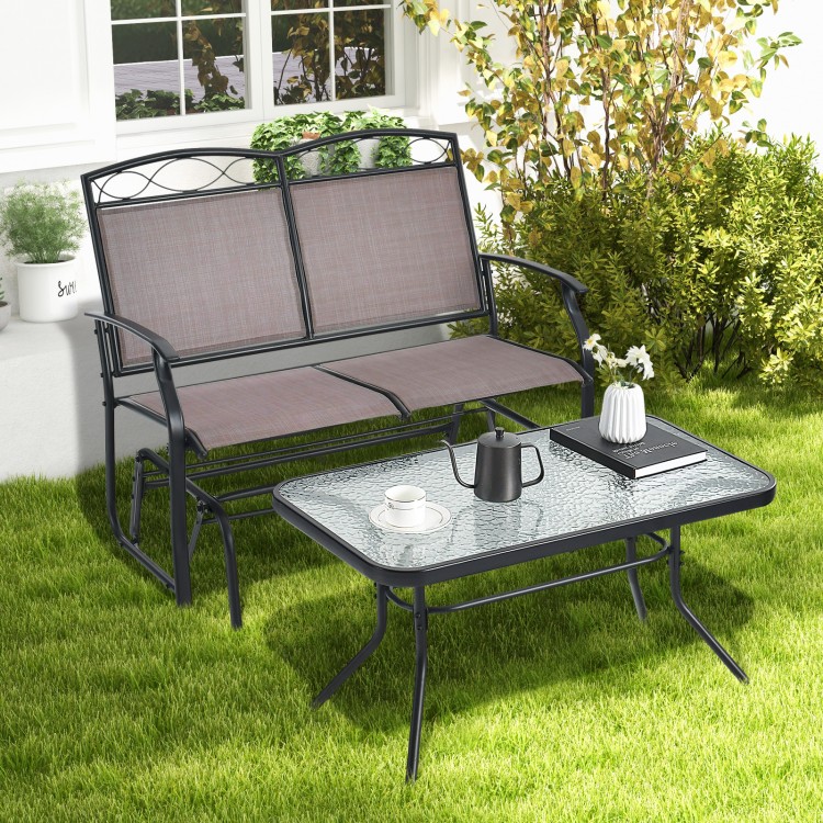 Outdoor gliding loveseat chair with tempered glass coffee table, featuring a stable base and ergonomic design for.