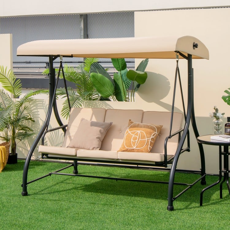 Three-seat outdoor porch swing with adjustable beige canopy, removable cushions, perfect for patio relaxation.