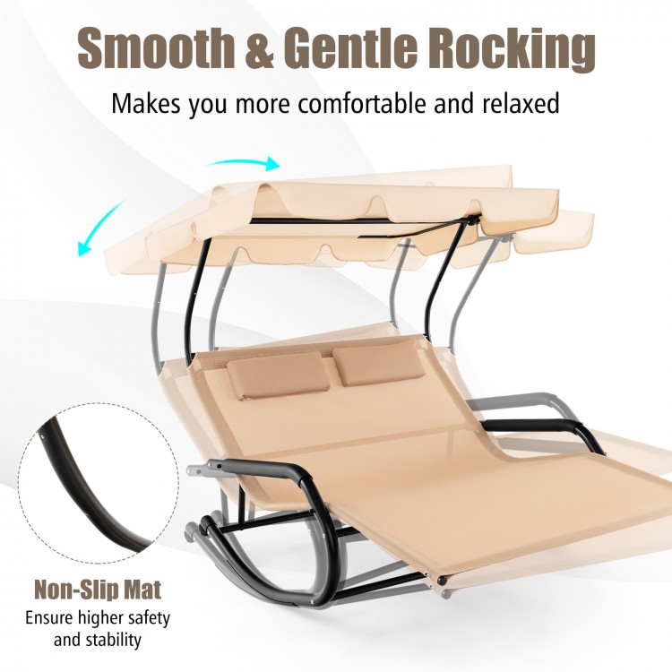 Beige outdoor rocking chaise lounge for 2 with adjustable canopy, soft pillows, and wheels for easy movement.