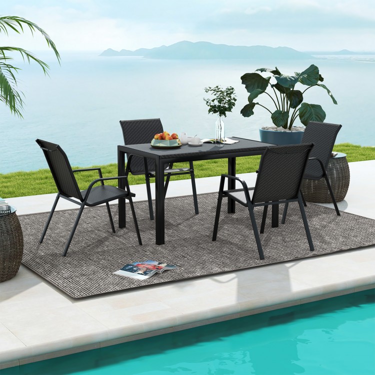 Four brown patio rattan dining chairs with wicker seats around a table, perfect for outdoor dining in the backyard.