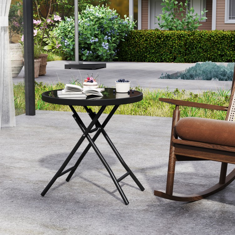 Round black folding side table with tempered glass top, ideal for outdoor use and easy to store.
