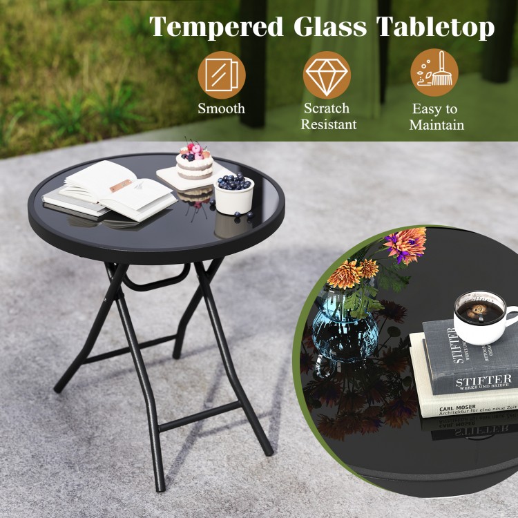 Round black folding side table with tempered glass top, ideal for indoor and outdoor use, lightweight and easy to.