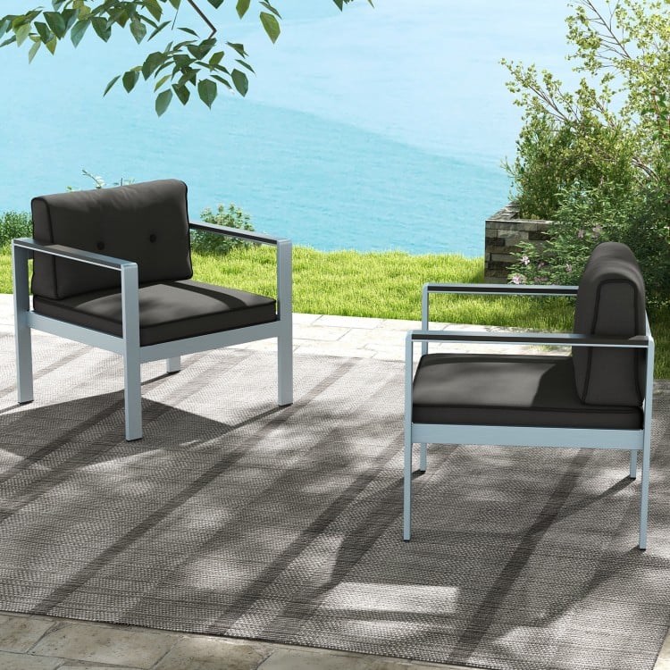 Contemporary gray sofa chairs with WPC armrests and cushions, perfect for outdoor relaxation by the water.