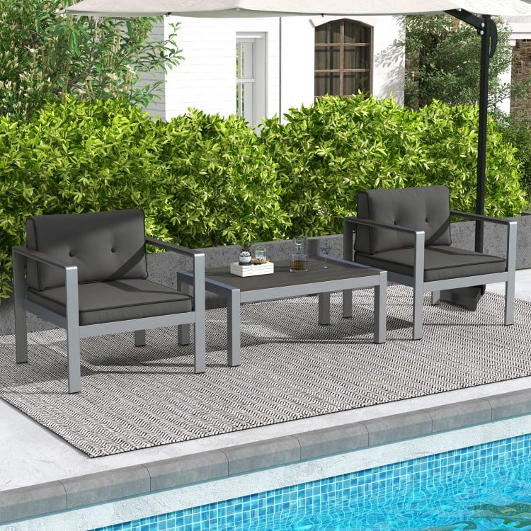 Contemporary gray sofa chairs with WPC armrests and cushions, perfect for outdoor relaxation by the pool.