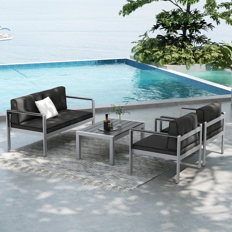 Contemporary 2-person sofa chairs with WPC armrests, featuring soft cushions, placed by a poolside for outdoor.