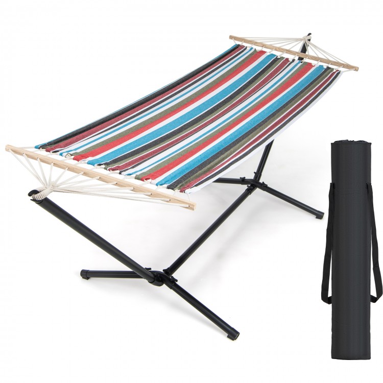 Multicolor hammock with heavy-duty metal stand and carrying case, suitable for garden or patio relaxation.