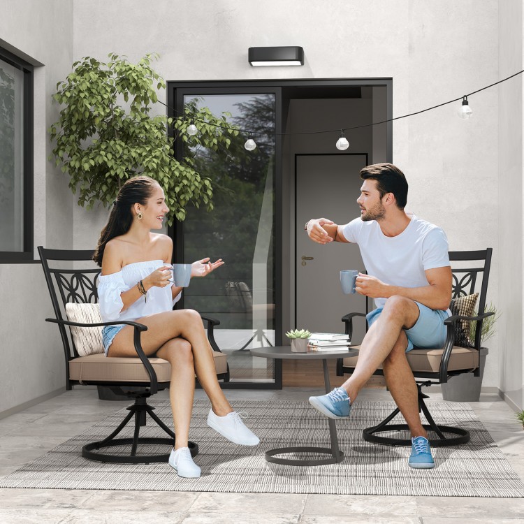 Two people enjoying coffee on 2 pieces patio swivel dining chairs with blossom pattern backrest and cushions in black.