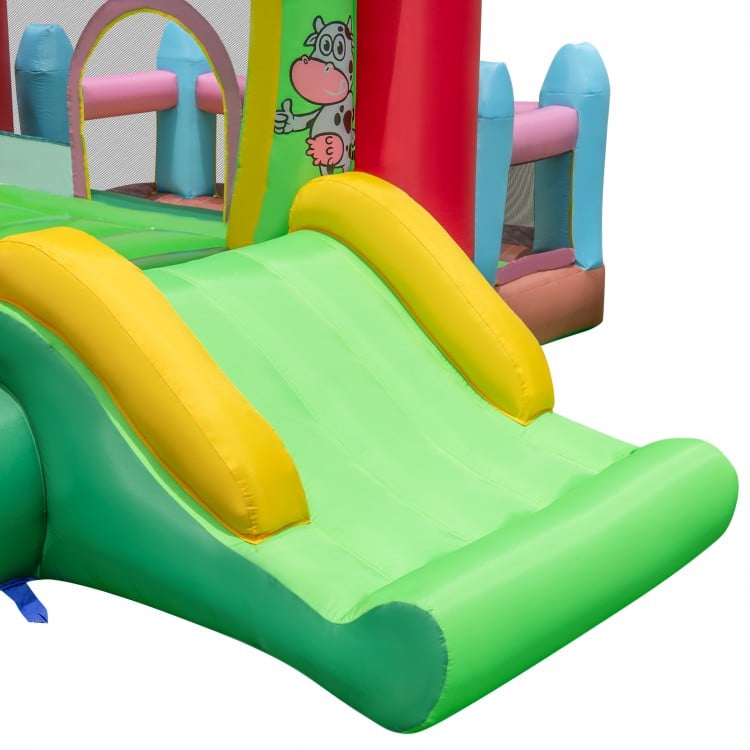 Bright green slide of the 4-in-1 inflatable bounce house, featuring a safe landing pad for kids' outdoor fun.