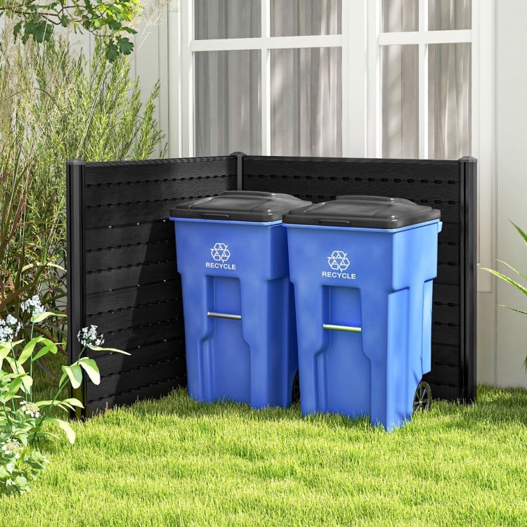Outdoor privacy fence screen in black with two blue recycling bins, ideal for concealing yard equipment and trash.