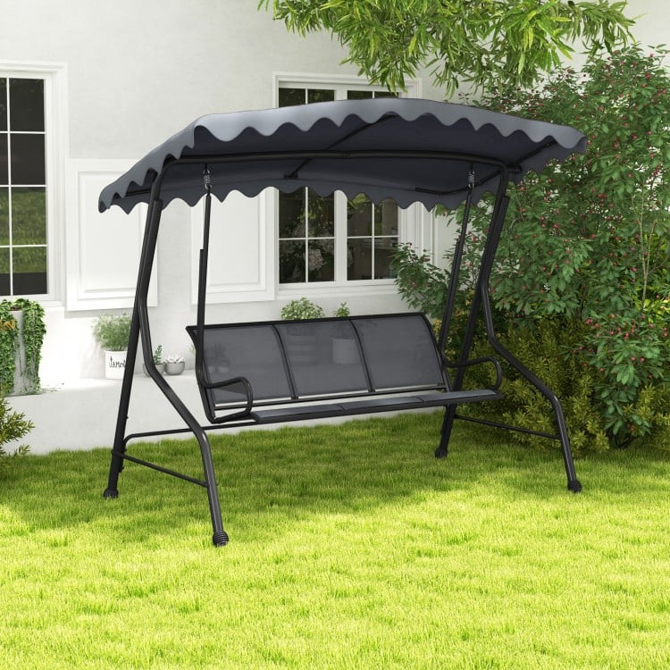 Gray 3-seat outdoor porch canopy swing with adjustable shading, robust metal frame, perfect for backyard relaxation.