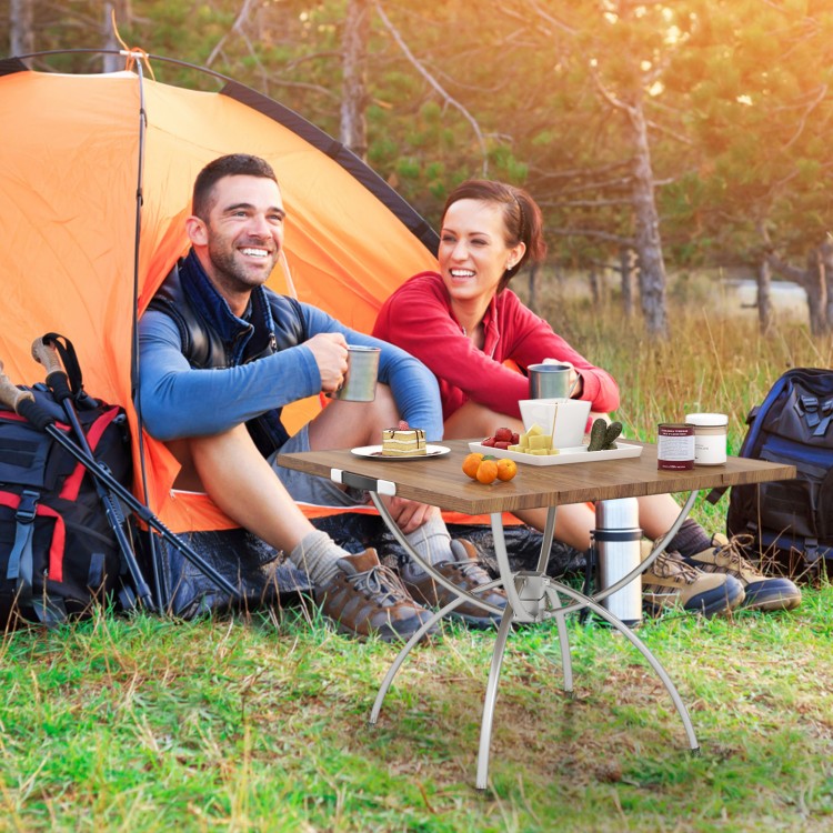 Folding camping table with wood-grain tabletop and aluminum legs, perfect for outdoor picnics and camping trips.