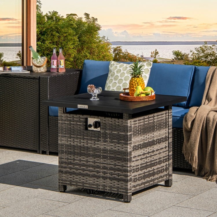 29-inch gray propane rattan firepit table with lava rocks, featuring a secure lid and stylish woven exterior for.