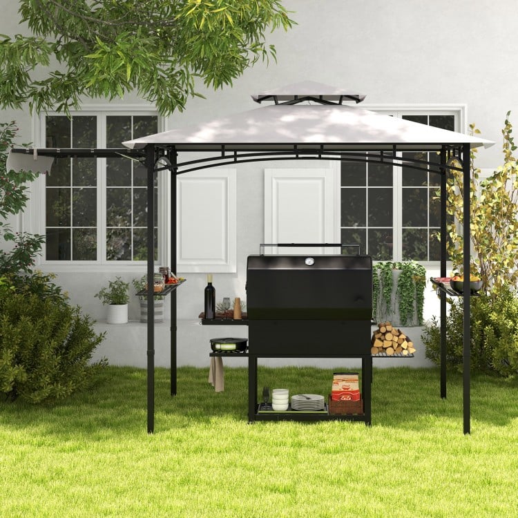 Grill gazebo with side awning and double-tiered top, featuring metal shelves and hooks for outdoor cooking essentials.