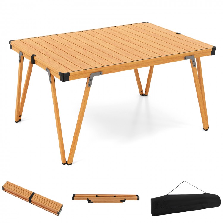 Folding camping table with a waterproof brown surface, sturdy aluminum frame, and portable storage bag for picnics and.