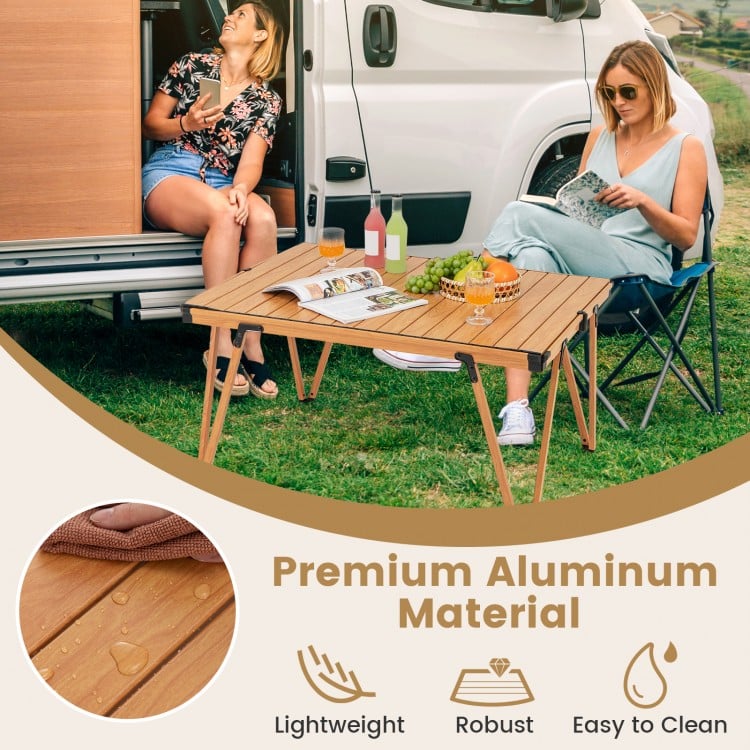 Folding camping table in brown with waterproof surface, ideal for picnics and camping, featuring a portable storage bag.