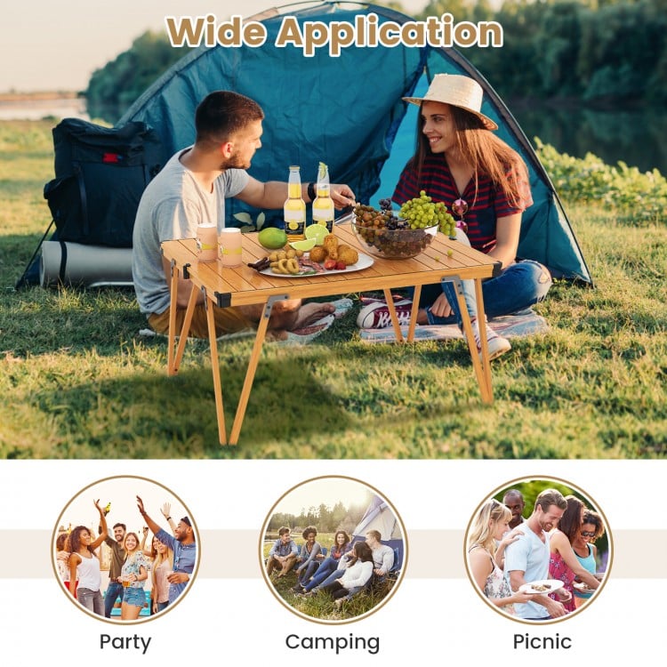 Folding camping table in brown with waterproof surface, perfect for picnics and camping, shown in outdoor setting.
