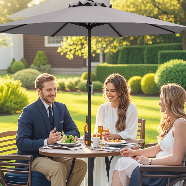 Gray outdoor market umbrella with crank handle, featuring a sturdy metal frame and 8 ribs, ideal for backyard dining.