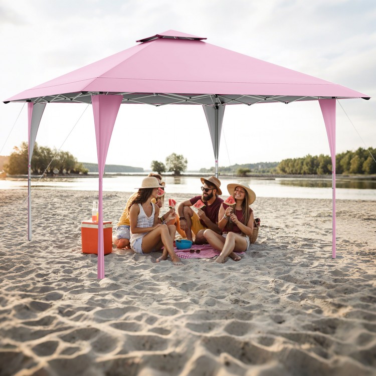 Pop-up gazebo in pink, 13 x 13 ft, providing shade for beach gatherings with sturdy stakes and wind ropes.