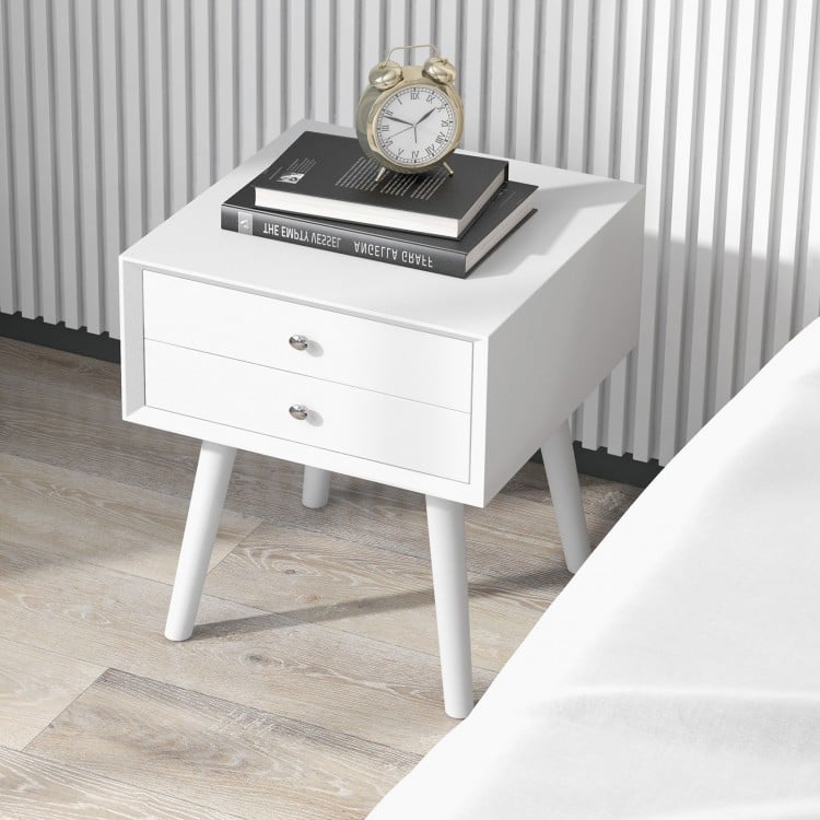White wooden nightstand with two storage drawers, featuring a solid wood frame, ideal for bedroom decor and efficient.