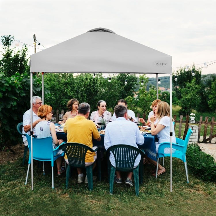 Gray 6.6 x 6.6 feet outdoor pop-up canopy tent providing shade for a large gathering, featuring a sturdy steel frame.