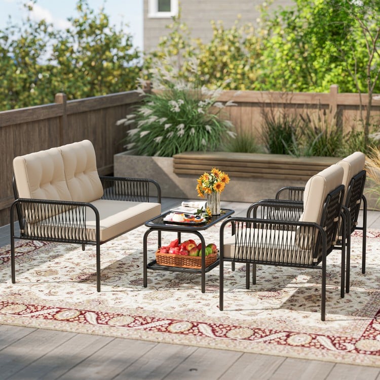 Beige PE rattan patio furniture set featuring a loveseat and two chairs with a coffee table, ideal for outdoor.