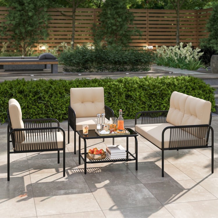 4-piece patio furniture set featuring beige PE rattan sofa chairs and a coffee table, ideal for outdoor relaxation.
