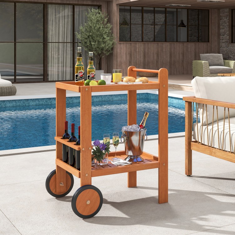 Rolling serving cart with teak oil finish, wine bottle holders, and rubber wheels, perfect for outdoor entertaining.